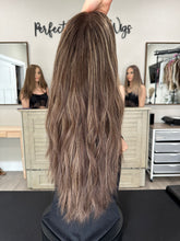 Load image into Gallery viewer, Dorothy is a 23” layered length, medium hand tied stretch cap with lace top made with premium Brazilian quality human hair