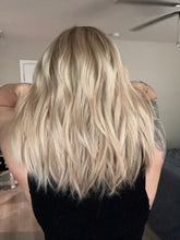 Load image into Gallery viewer, Avery is a 15” length with curtain bangs, medium cap made with premium Brazilian quality human hair