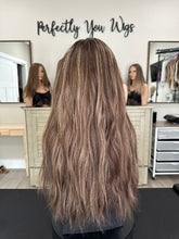 Load image into Gallery viewer, Dorothy is a 23” layered length, medium hand tied stretch cap with lace top made with premium Brazilian quality human hair