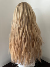 Load image into Gallery viewer, Lucy is a 25” layered length, small cap made with premium Brazilian quality human hair