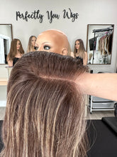 Load image into Gallery viewer, Dorothy is a 23” layered length, medium hand tied stretch cap with lace top made with premium Brazilian quality human hair