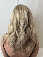 Load image into Gallery viewer, Evie is a 17" layered length, medium cap made with a premium Brazilian quality human hair