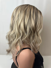 Load image into Gallery viewer, Evie is a 17" layered length, medium cap made with a premium Brazilian quality human hair
